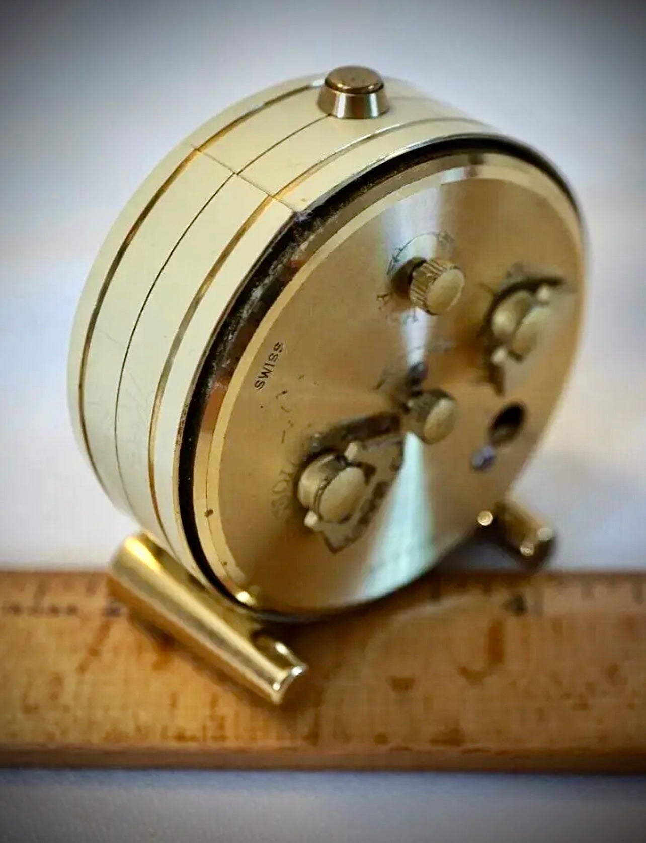 R75. VTG LOOPING 15 JEWELS 8 DAY SWISS TRAVEL ALARM CLOCK BRASS W/FACE & WHITE BODY
