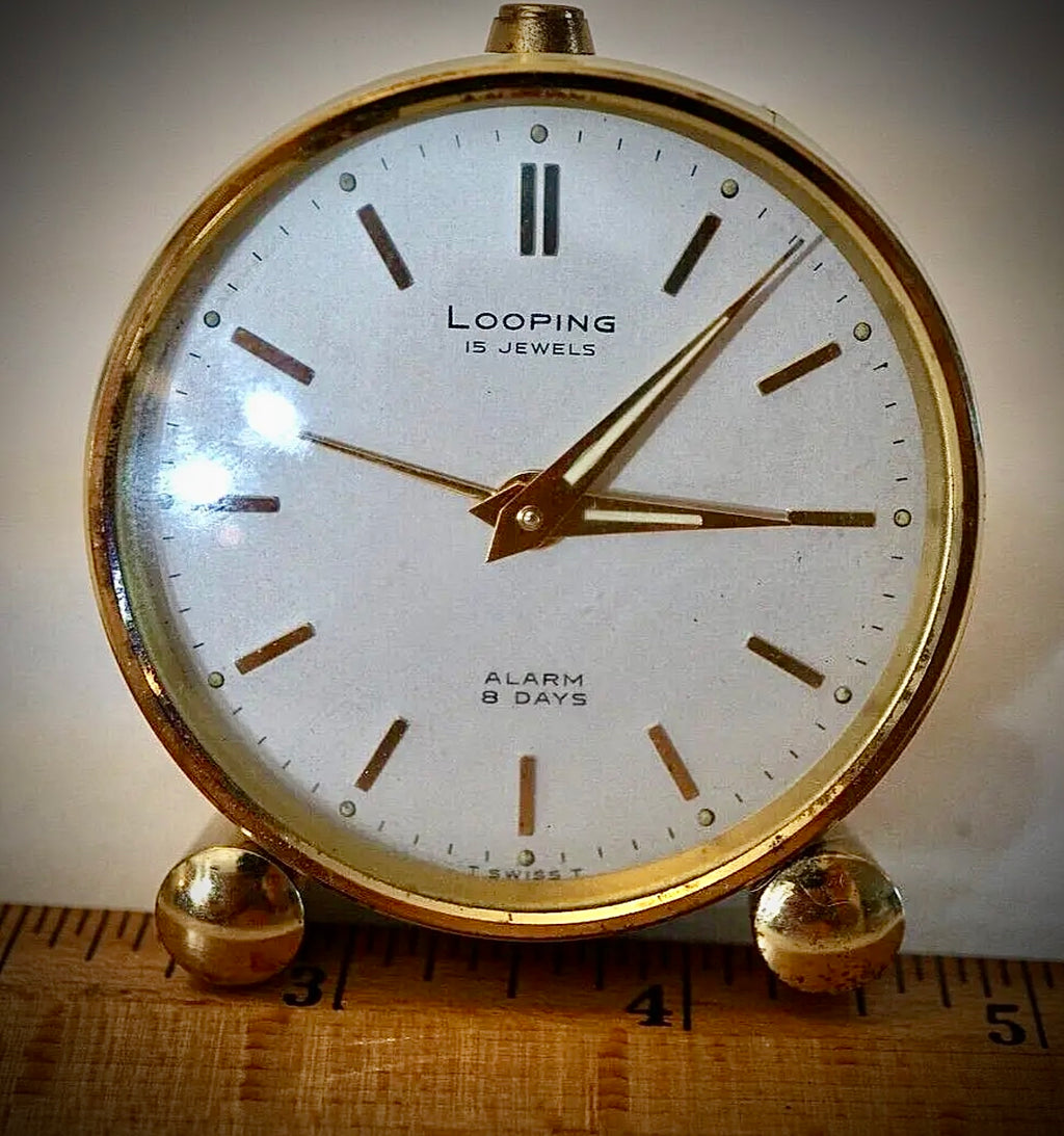 R75. VTG LOOPING 15 JEWELS 8 DAY SWISS TRAVEL ALARM CLOCK BRASS W/FACE & WHITE BODY