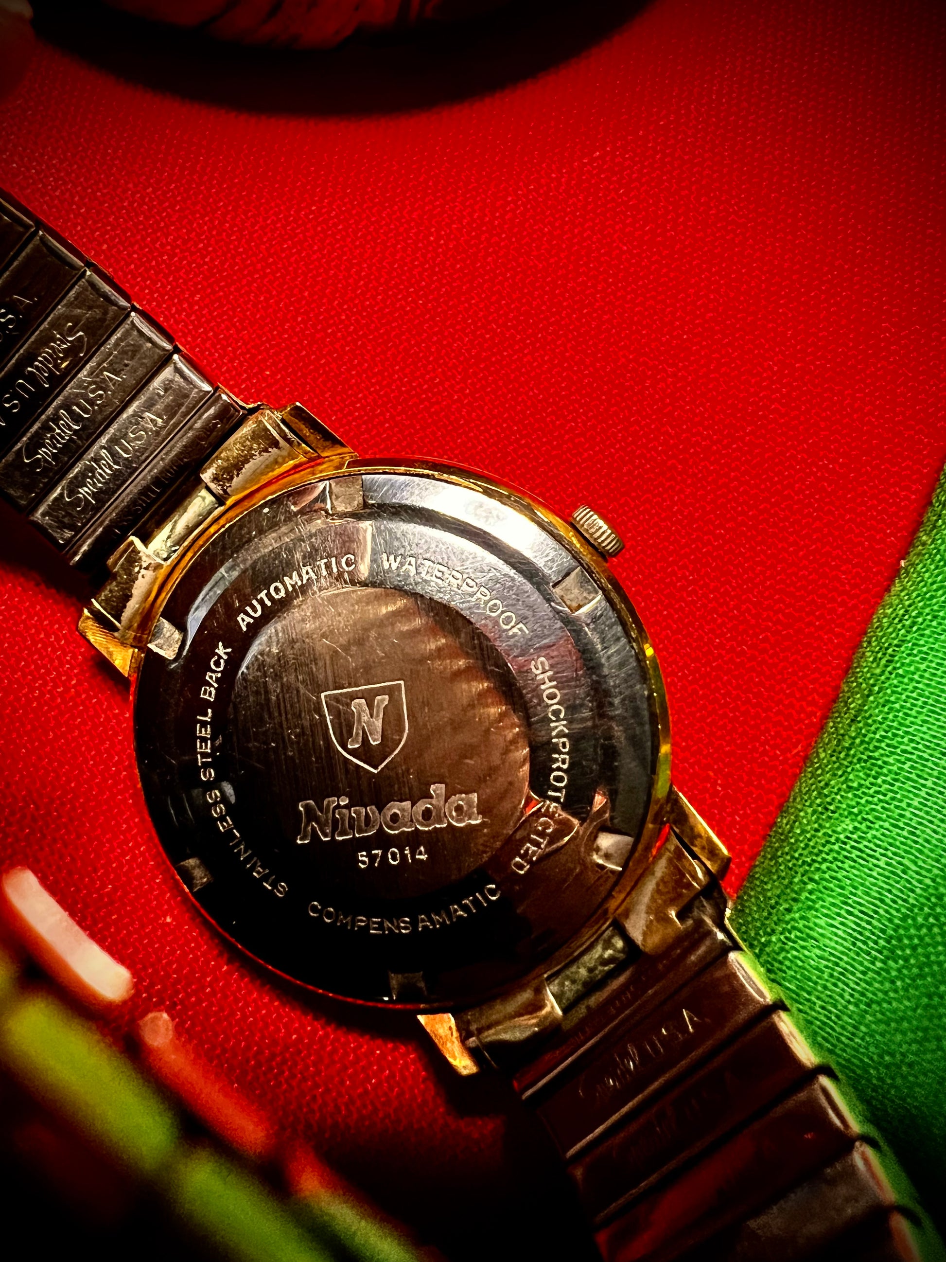 #1351 Nivada Date Automatic Gold color with Gold dial newish beautiful S.S back Spidiel USA gold filled caps all original watch great opportunity for Collectors rate watch in excellent running and beautiful condition. Power 266 beat error 0.1 ms