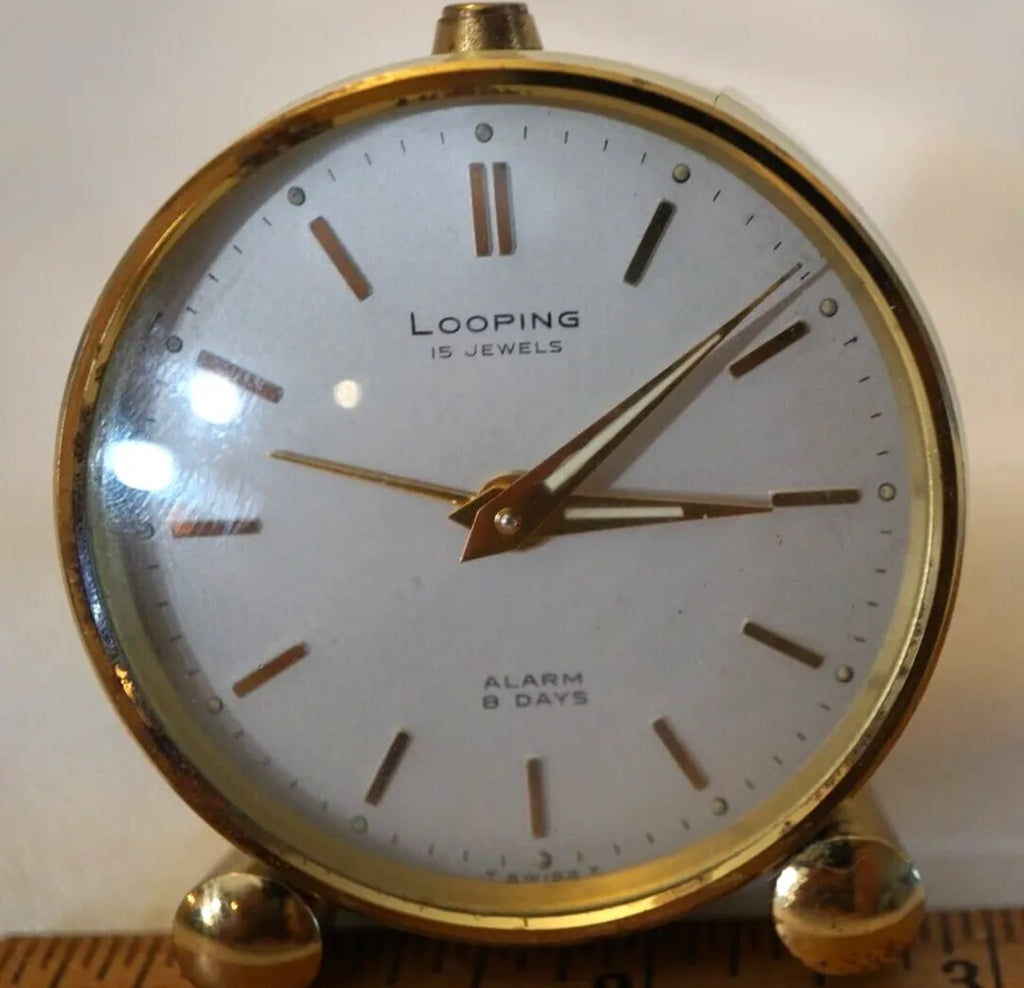 R75. VTG LOOPING 15 JEWELS 8 DAY SWISS TRAVEL ALARM CLOCK BRASS W/FACE & WHITE BODY