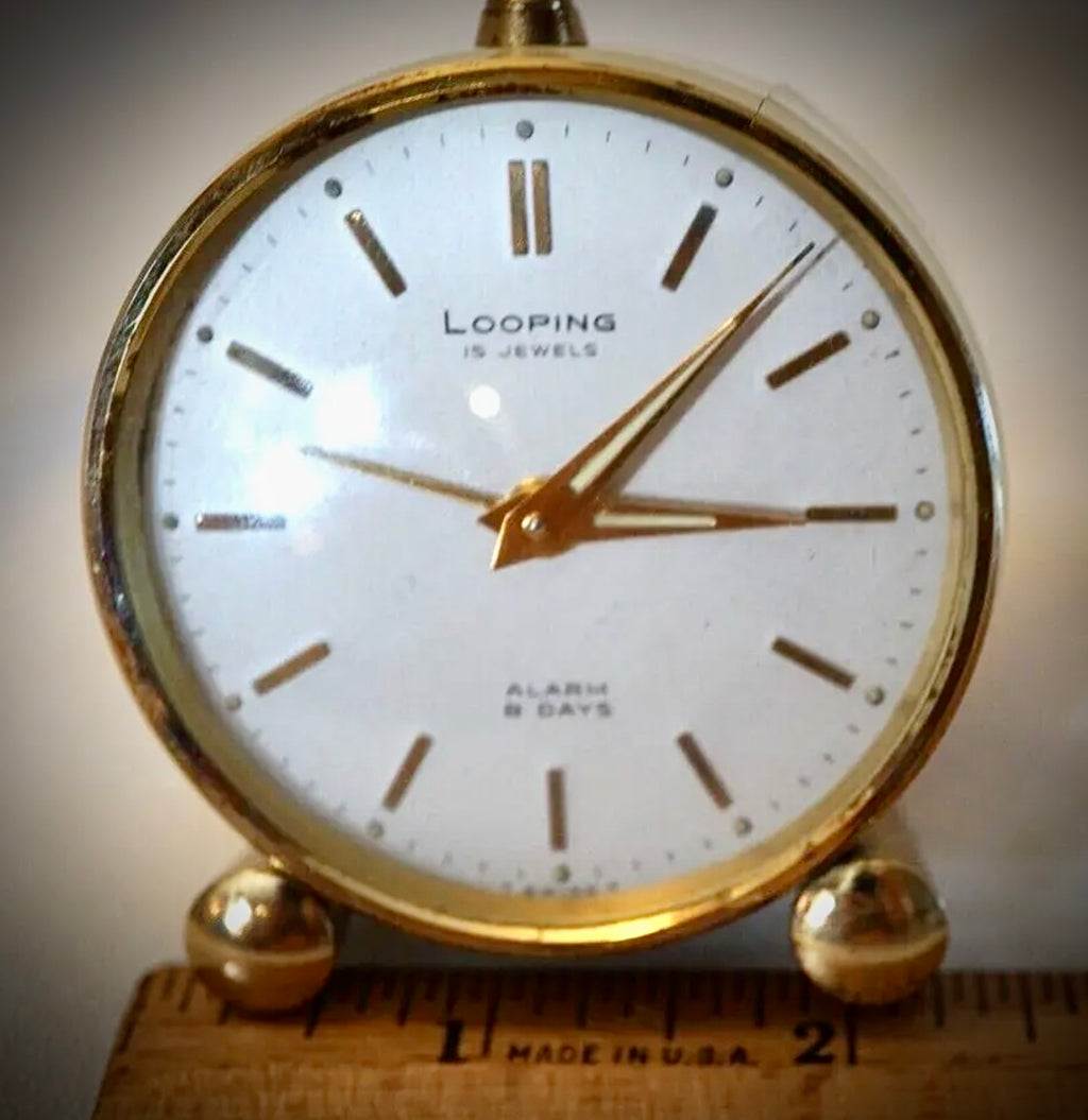 R75. VTG LOOPING 15 JEWELS 8 DAY SWISS TRAVEL ALARM CLOCK BRASS W/FACE & WHITE BODY